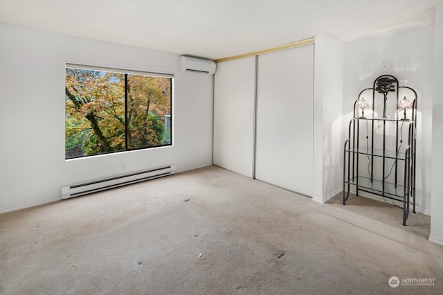 carpeted empty room featuring a wall mounted AC, a textured ceiling, and a baseboard heating unit