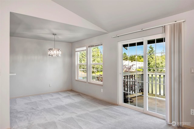 unfurnished room with light colored carpet, lofted ceiling, and a chandelier