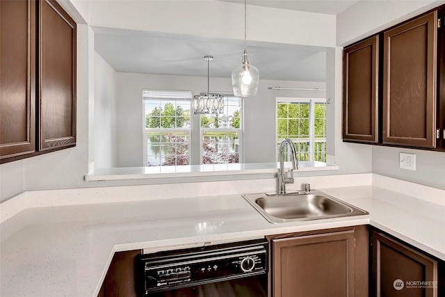 kitchen with pendant lighting, dishwasher, a healthy amount of sunlight, and sink