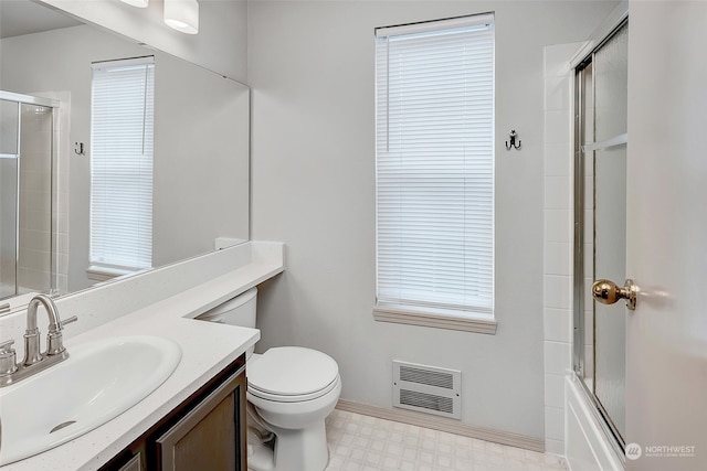 full bathroom with vanity, toilet, a wealth of natural light, and enclosed tub / shower combo