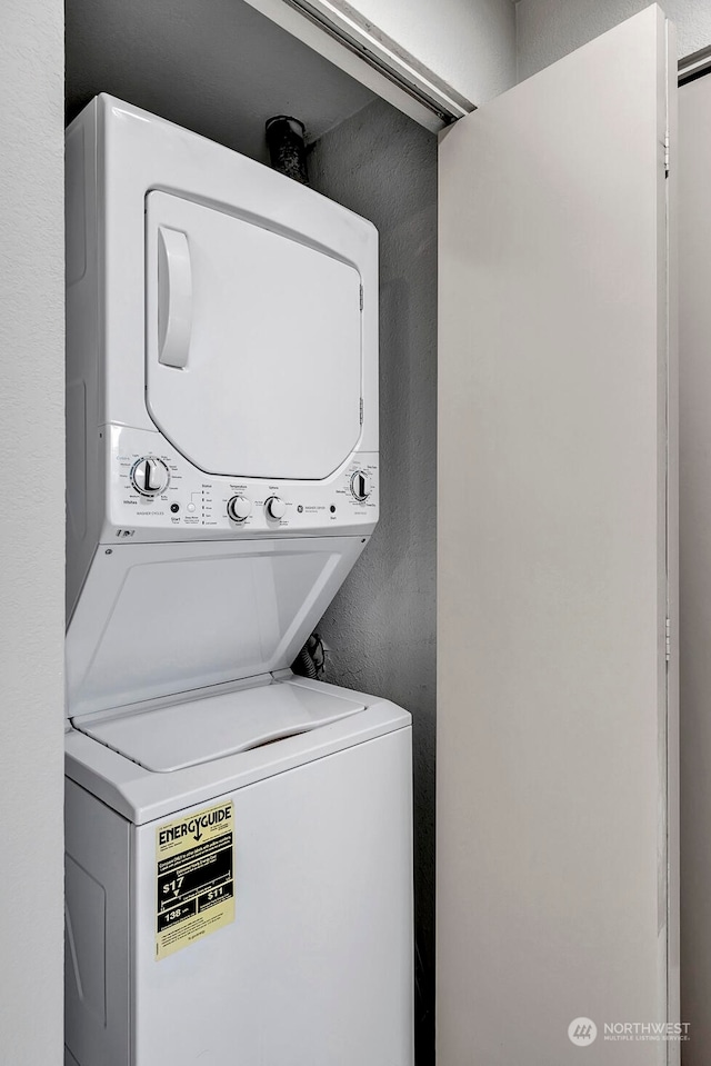 laundry area with stacked washer / dryer