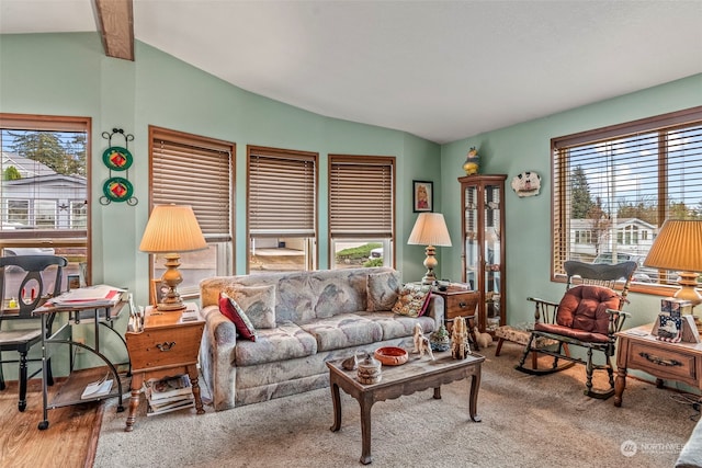 living room with hardwood / wood-style floors and vaulted ceiling with beams