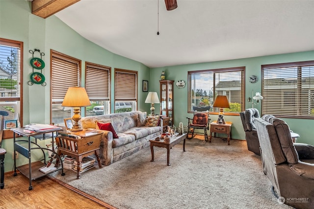 living room featuring a wealth of natural light and lofted ceiling with beams