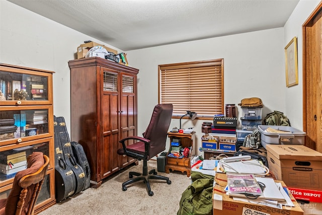 carpeted home office with a textured ceiling