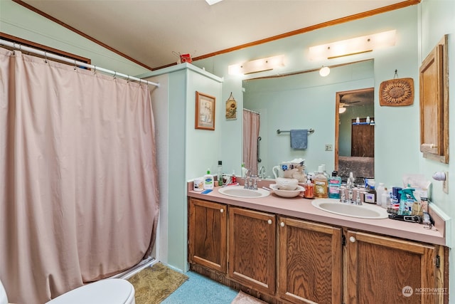 bathroom featuring vanity, vaulted ceiling, ceiling fan, ornamental molding, and walk in shower