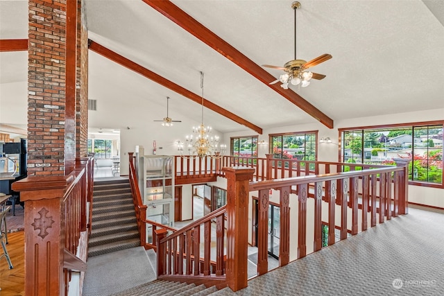 staircase featuring beam ceiling, a textured ceiling, high vaulted ceiling, and a notable chandelier