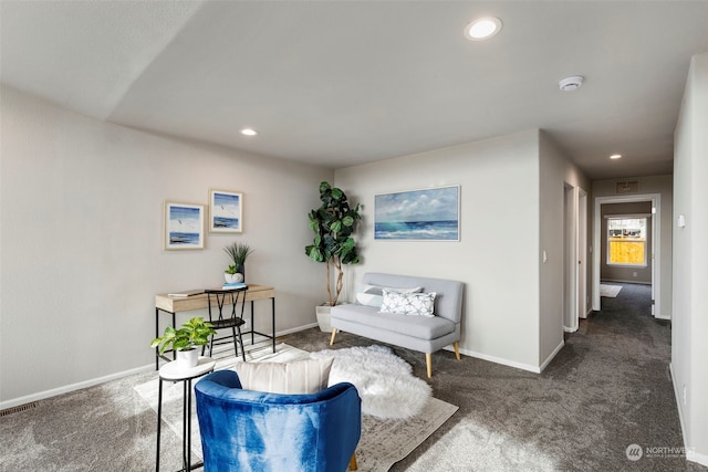 living area with dark colored carpet