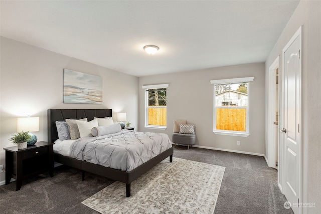 bedroom featuring dark carpet and multiple windows