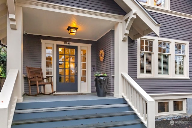 view of exterior entry featuring a porch