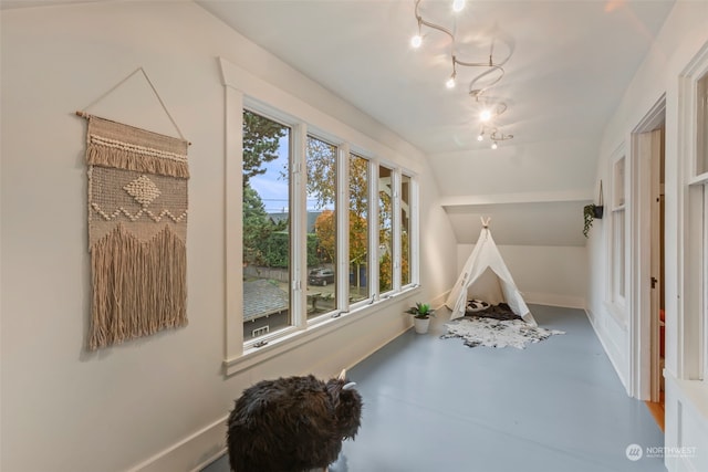 playroom with concrete flooring and lofted ceiling