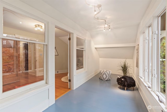 sunroom / solarium featuring vaulted ceiling