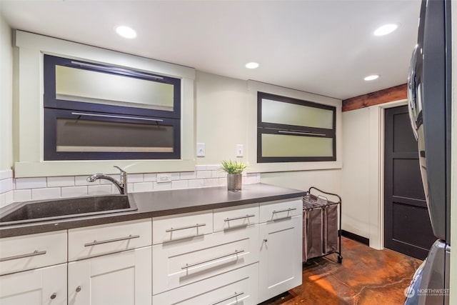 2033 11th Ave E, Seattle, WA 98102 - kitchen with a sink, dark countertops, white cabinetry, finished concrete flooring, and recessed lighting