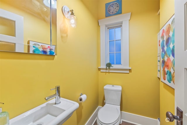 2033 11th Ave E, Seattle, WA 98102 - bathroom with toilet, a sink, and baseboards