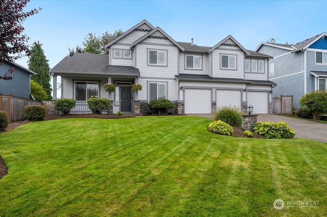 view of front of home with a garage and a front lawn