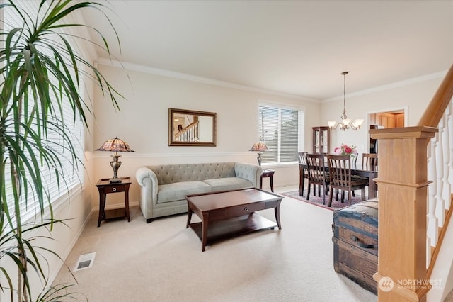 carpeted living room with ornamental molding and a chandelier