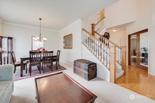 dining room with a chandelier, hardwood / wood-style floors, and crown molding