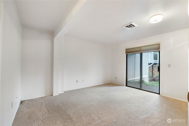 carpeted spare room with visible vents