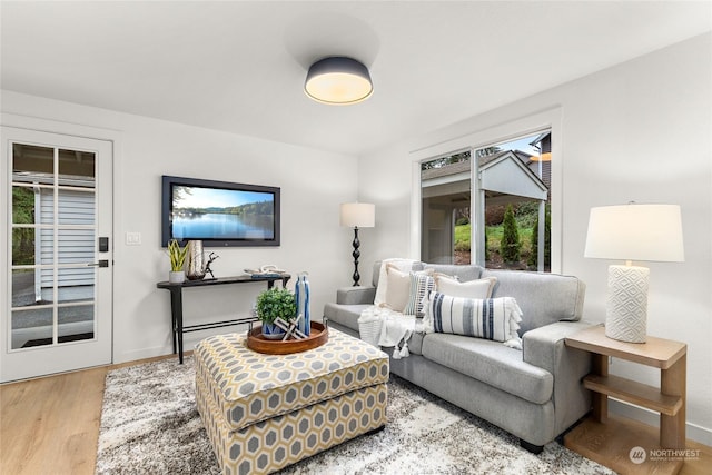 living room featuring baseboard heating and light wood-type flooring