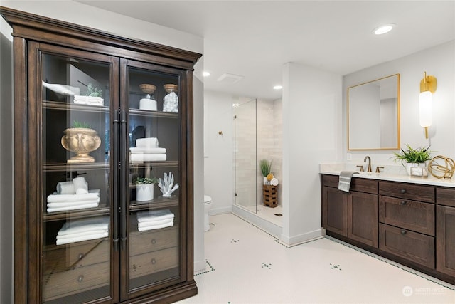 bathroom featuring a shower, vanity, and toilet