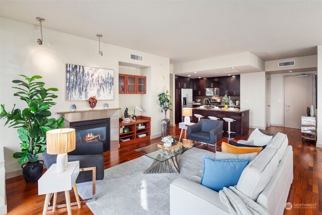 living room with dark hardwood / wood-style flooring