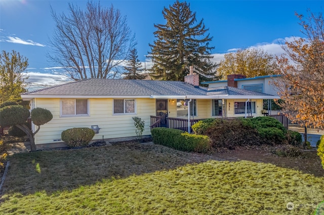 single story home featuring covered porch and a front yard