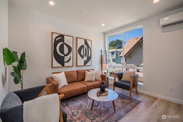 living room featuring a wall mounted AC and light wood-type flooring