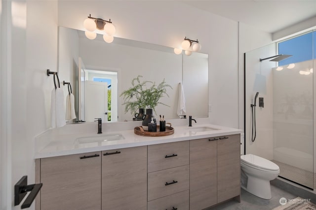 bathroom with a shower with door, vanity, and toilet