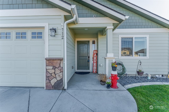 view of exterior entry with a garage