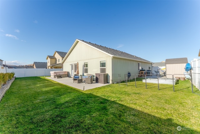 rear view of house featuring a patio area, a yard, a hot tub, and an outdoor hangout area