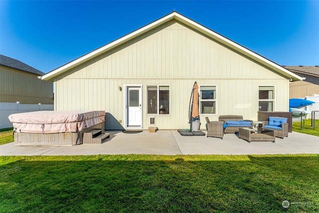 rear view of house with a patio area, a yard, and an outdoor hangout area