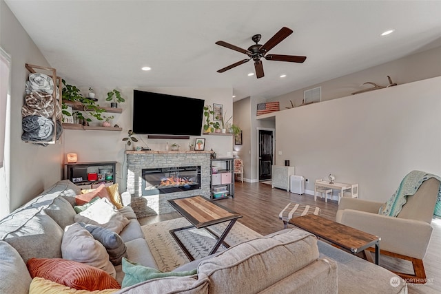 living room featuring a fireplace, ceiling fan, hardwood / wood-style floors, and lofted ceiling