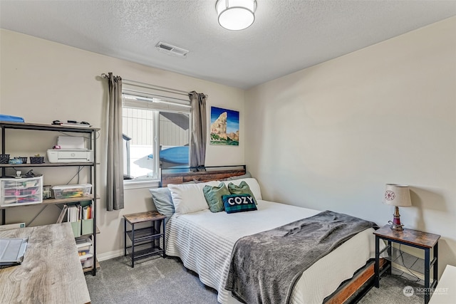 carpeted bedroom featuring a textured ceiling