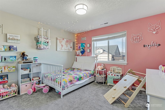 bedroom with carpet floors and a textured ceiling