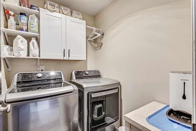 laundry room with cabinets and washing machine and dryer