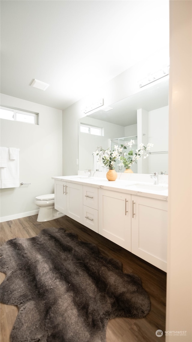 bathroom featuring vanity, hardwood / wood-style floors, and toilet