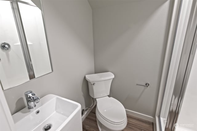 bathroom with sink, wood-type flooring, and toilet