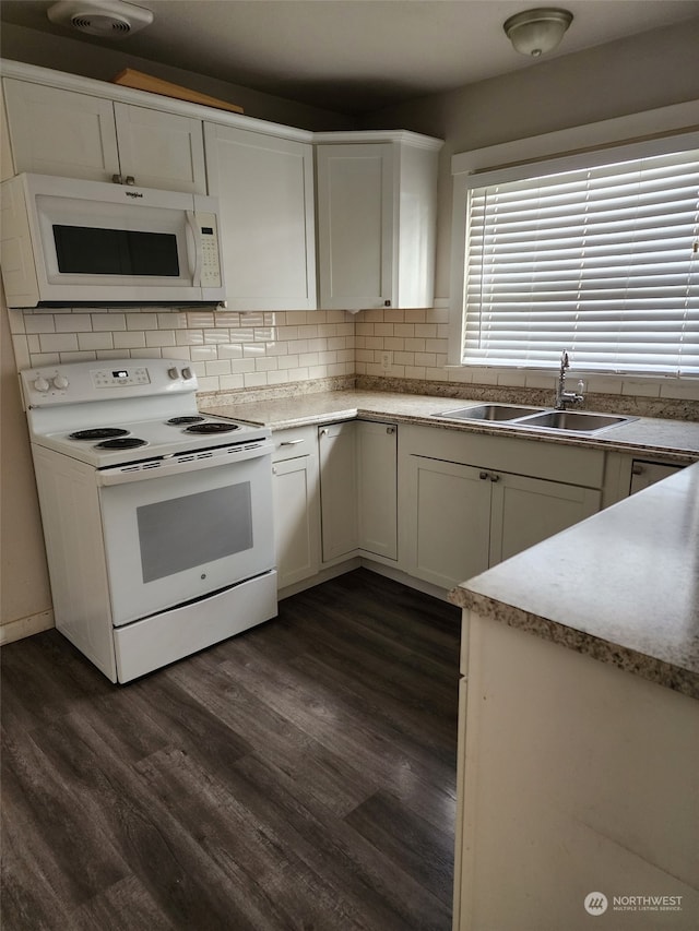 kitchen with white cabinetry, dark hardwood / wood-style flooring, white appliances, and sink