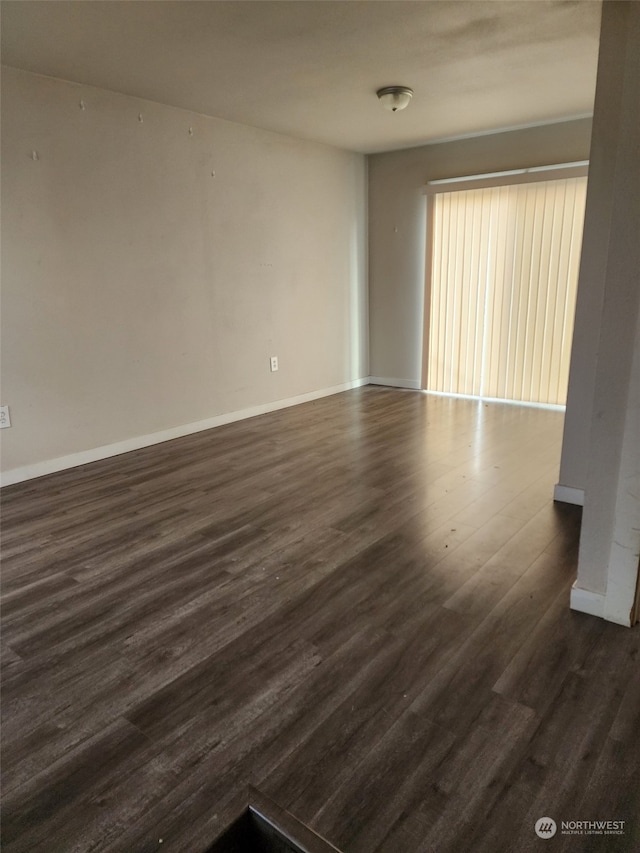 unfurnished room featuring dark hardwood / wood-style flooring