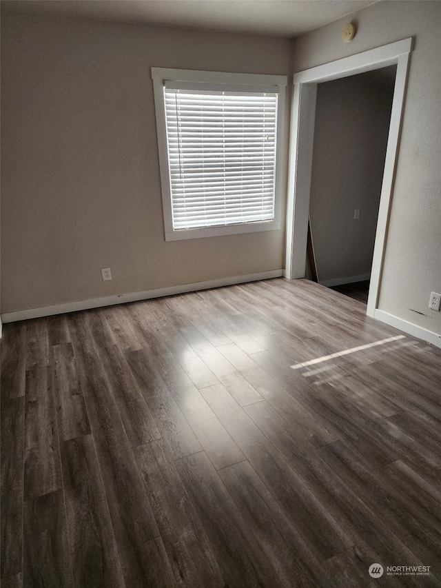 spare room featuring dark wood-type flooring