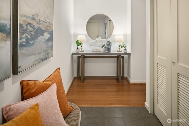 corridor with dark hardwood / wood-style flooring