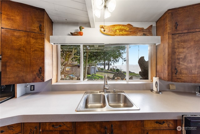 kitchen with beamed ceiling and sink