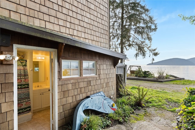 view of home's exterior with a mountain view and sink