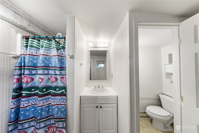 bathroom featuring toilet, vanity, tile patterned flooring, and baseboard heating