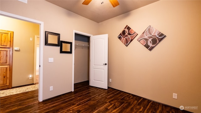 unfurnished bedroom with ceiling fan, dark hardwood / wood-style floors, and a closet