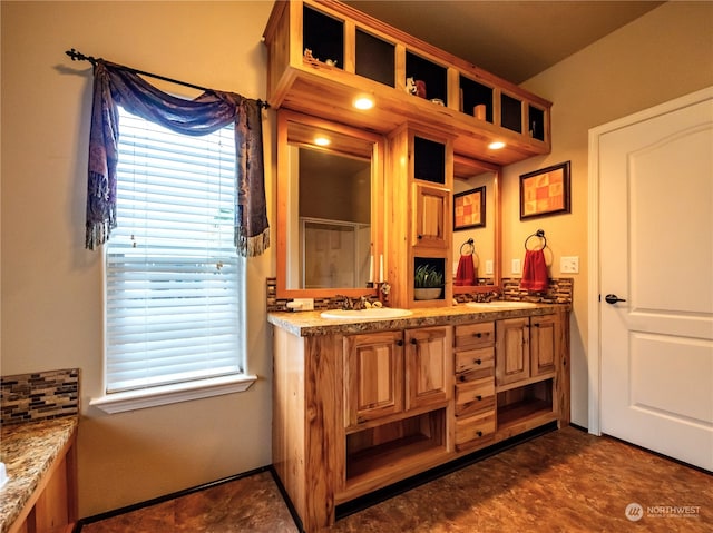 bathroom featuring vanity and a shower with shower door