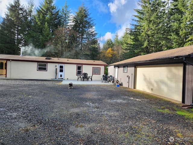 view of front of home featuring a patio area and a garage