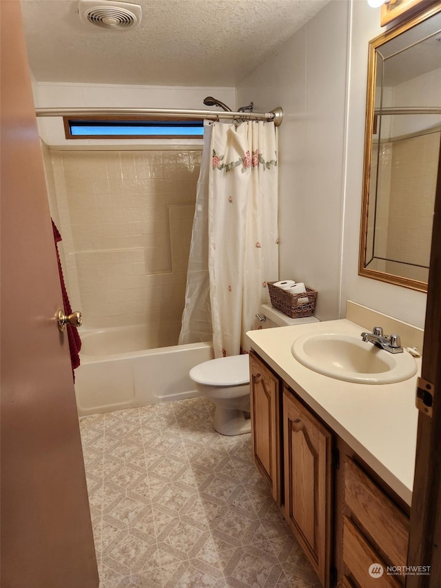 full bathroom with vanity, a textured ceiling, shower / bath combo, and toilet