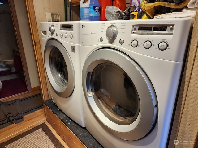 laundry room featuring hardwood / wood-style floors and separate washer and dryer