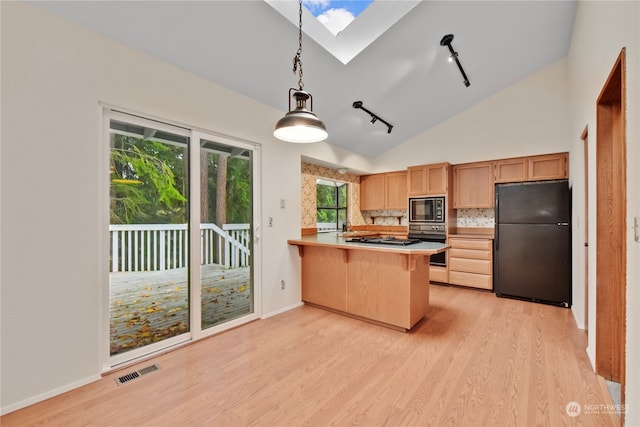 kitchen with kitchen peninsula, track lighting, a breakfast bar, black appliances, and hanging light fixtures