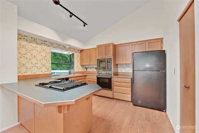 kitchen with kitchen peninsula, light brown cabinets, lofted ceiling, and black appliances